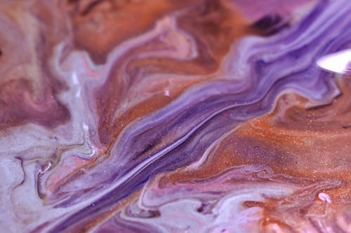 Free Flowing multicolored fluids on uneven surface Stock Photo