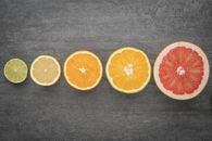 Sliced Orange Fruit on Black Textile