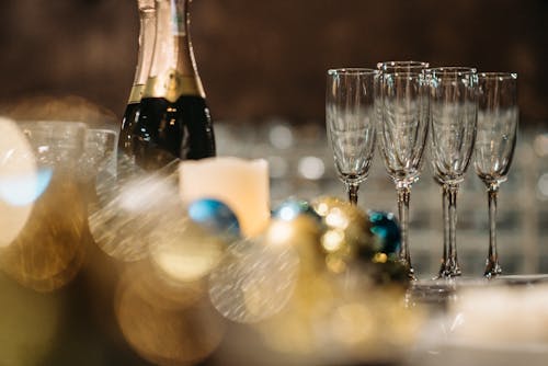 Close Up Photo of Champagne Bottles and Wine Glasses