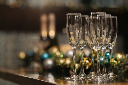 Free Stylish champagne flutes on a festive table setting with blurred Christmas decorations. Stock Photo