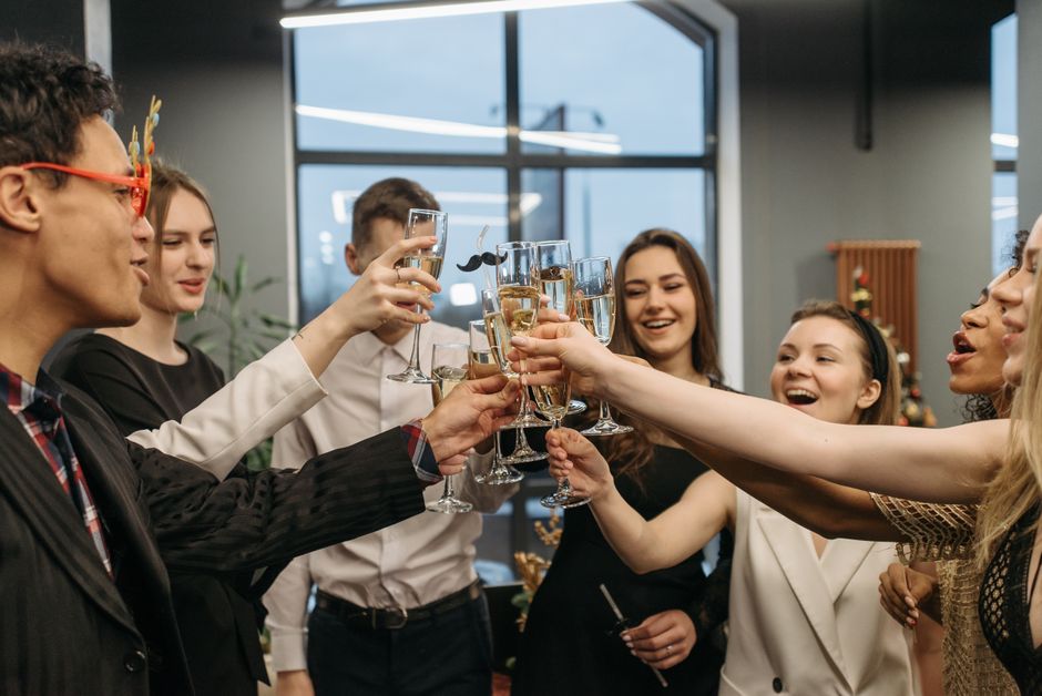 Um grupo alegre fazendo um brinde com champanhe em uma celebração festiva interna.