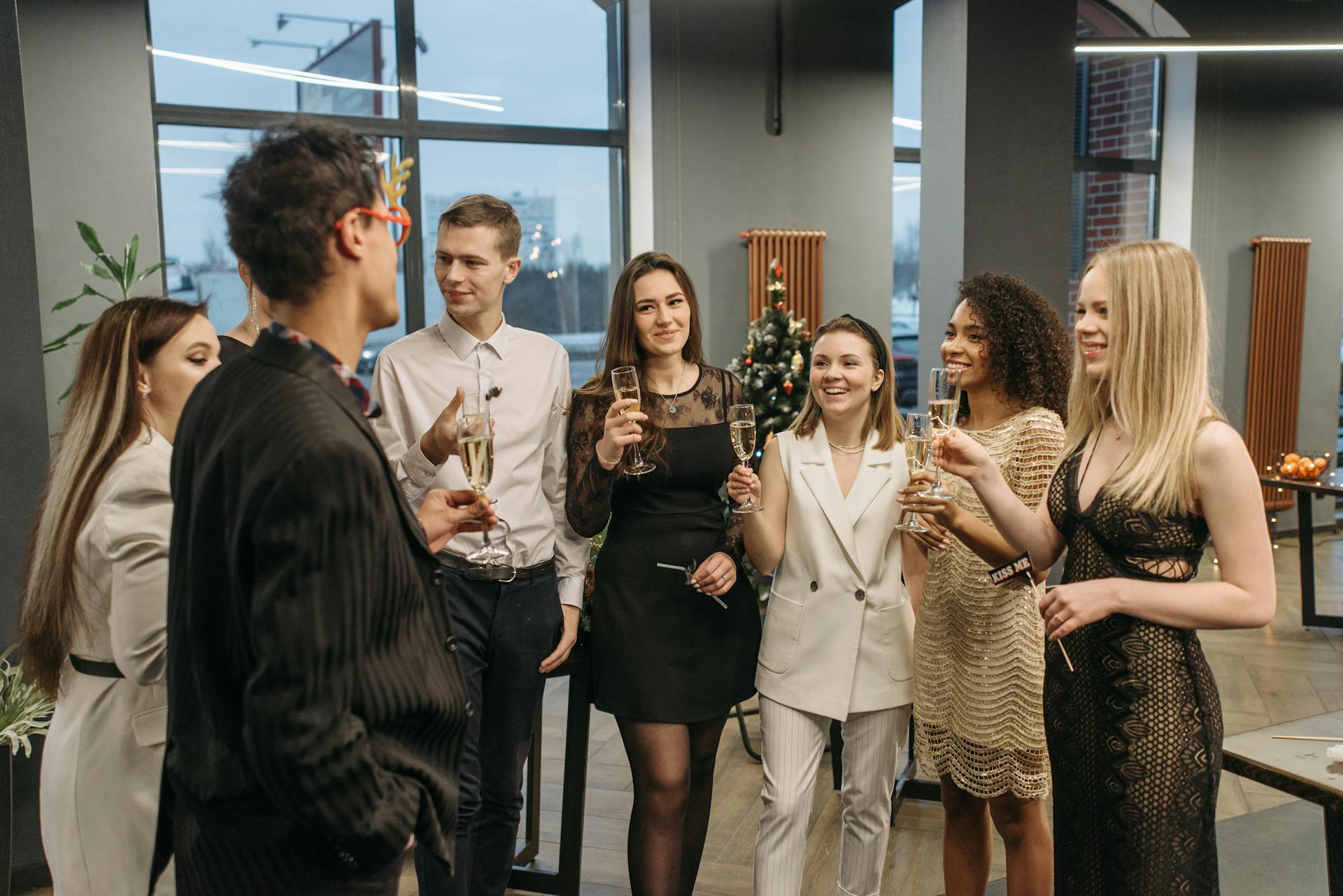 A festive office celebration with colleagues toasting during a corporate holiday party.