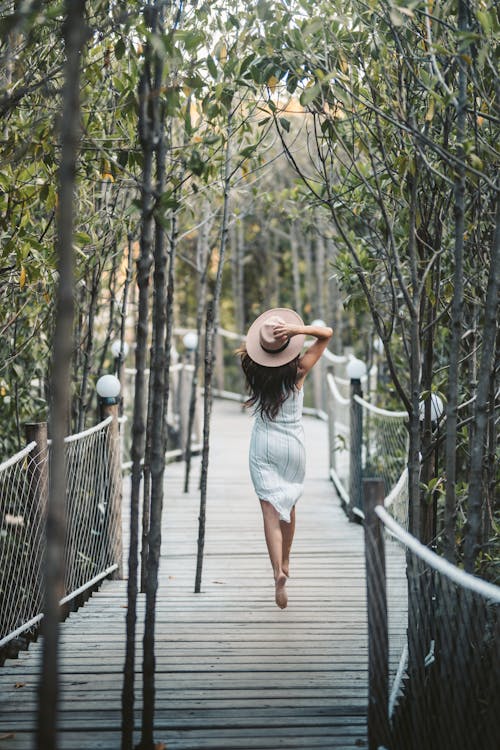 Free Back View of a Woman Walking in the Bridge Stock Photo