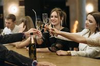 Women Tossing Their Glasses of Champagne