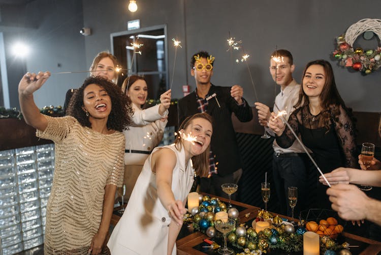 A Team Holding Sparklers And Having A Celebration In The Office