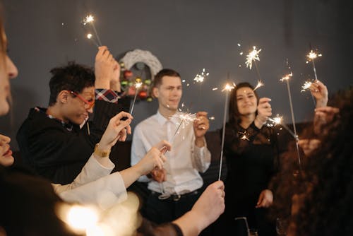 People Holding Sparklers