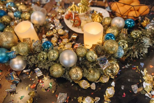 Lighted Candles and Christmas Balls on a Table
