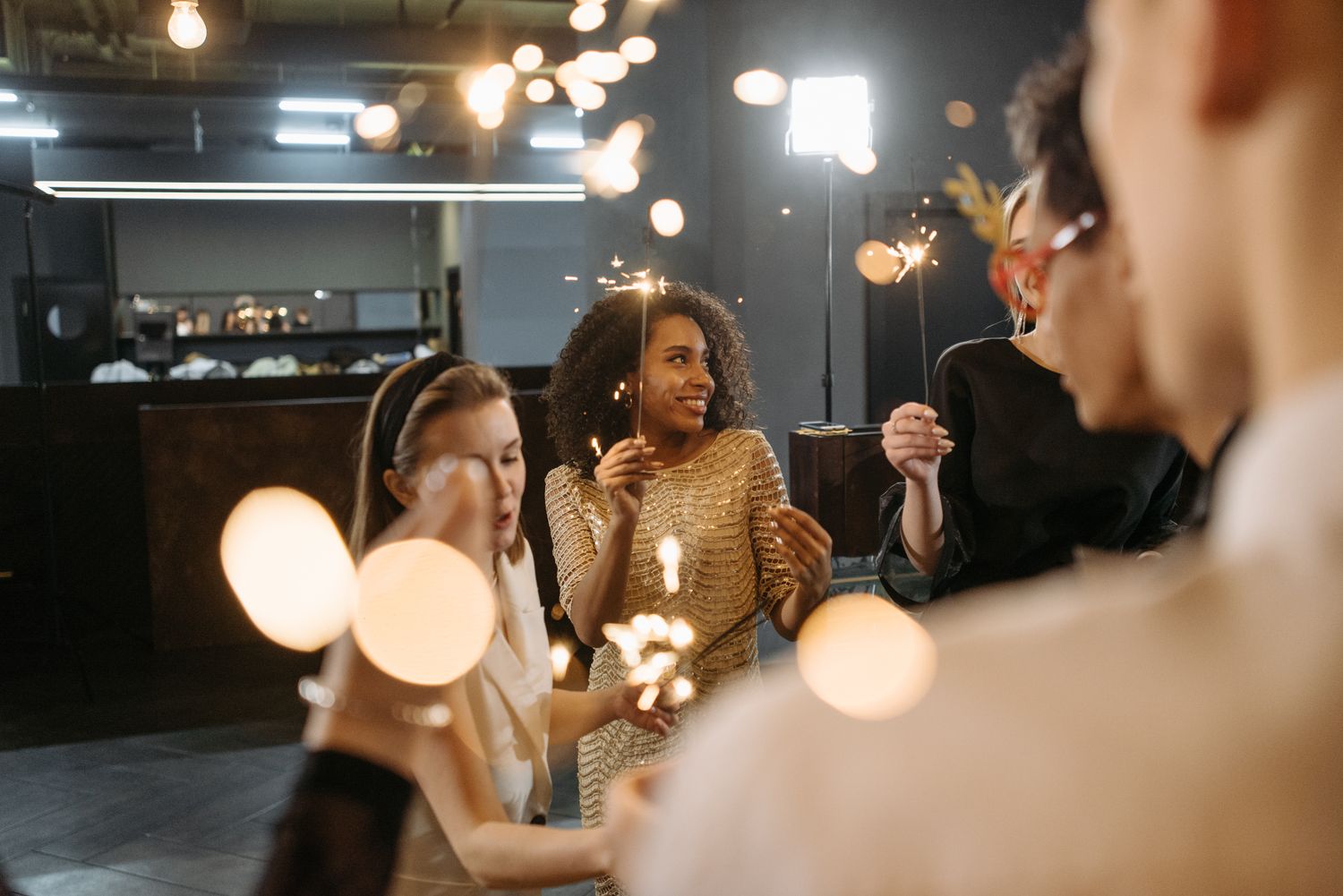 Friends celebrating with sparklers at a festive party