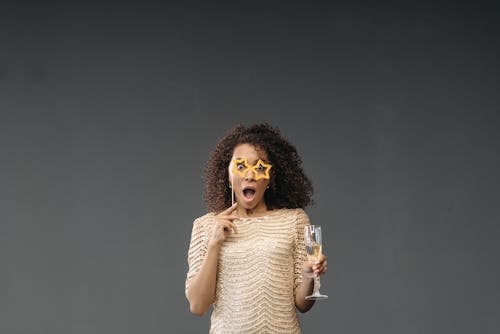 Free Surprised Woman holding Glass of Champagne Stock Photo