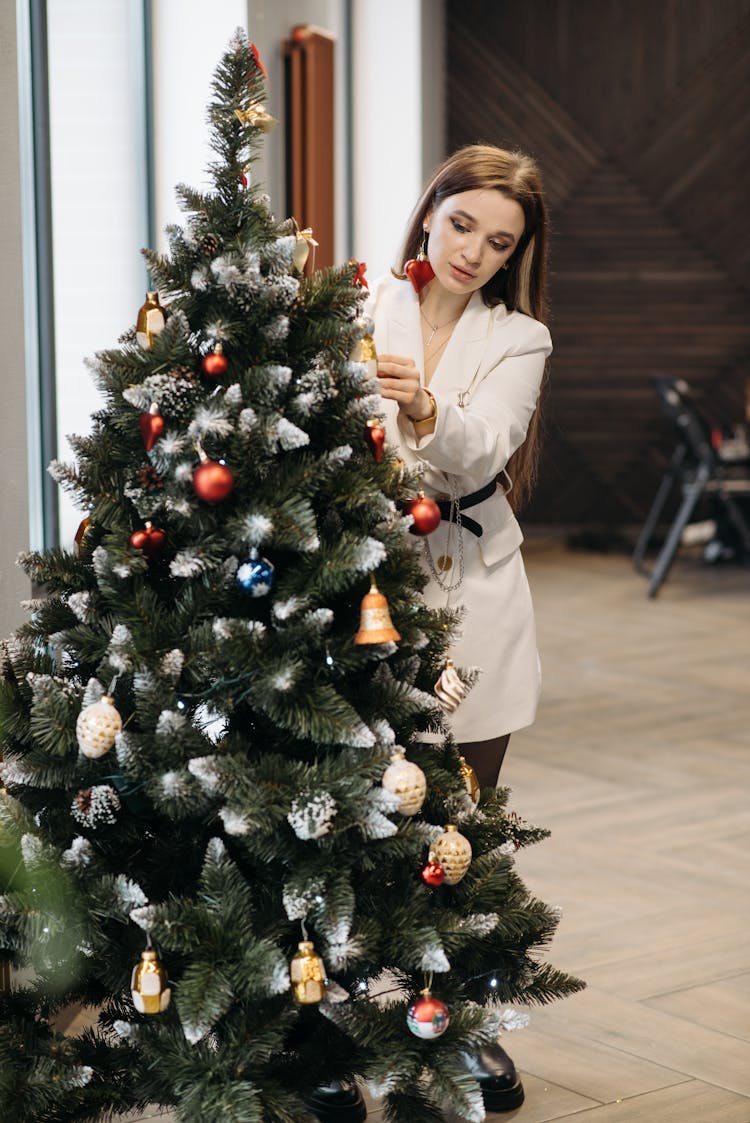 Woman Decorating A Christmas Tree