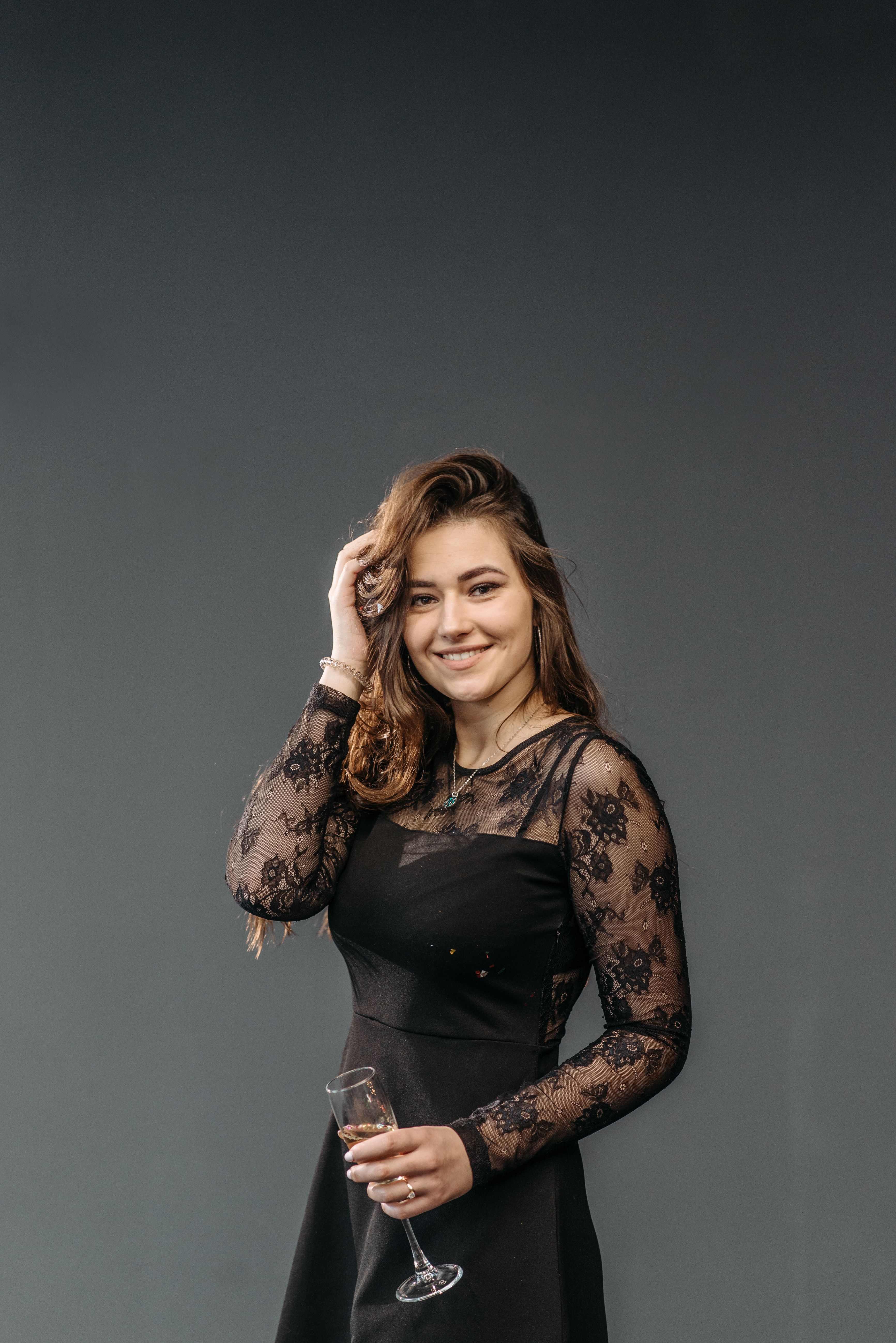A Woman in Black Dress Holding a Glass of Wine · Free Stock Photo
