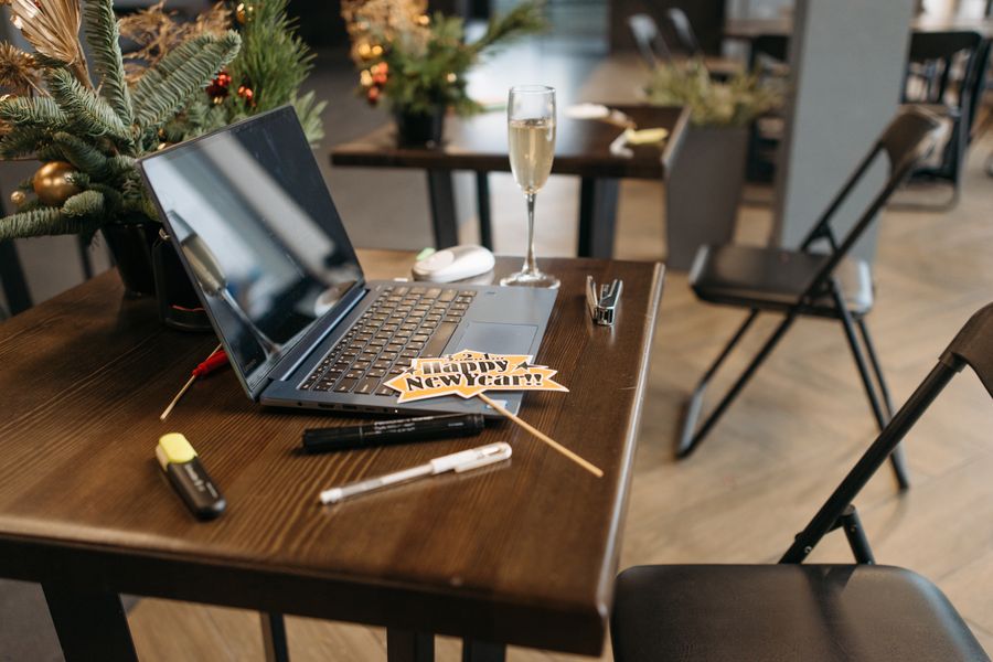 Office desk with laptop and New Year decorations creating a festive work environment.