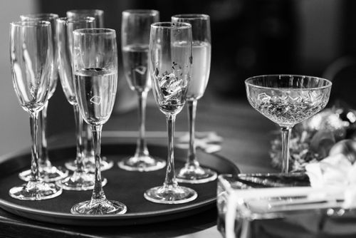 Free Champagne glasses on a tray capture the essence of celebration in this elegant monochrome setting. Stock Photo