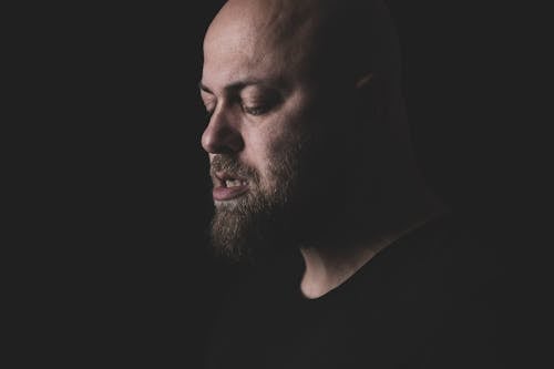 Close Up Photo of a Bald Man with Beard