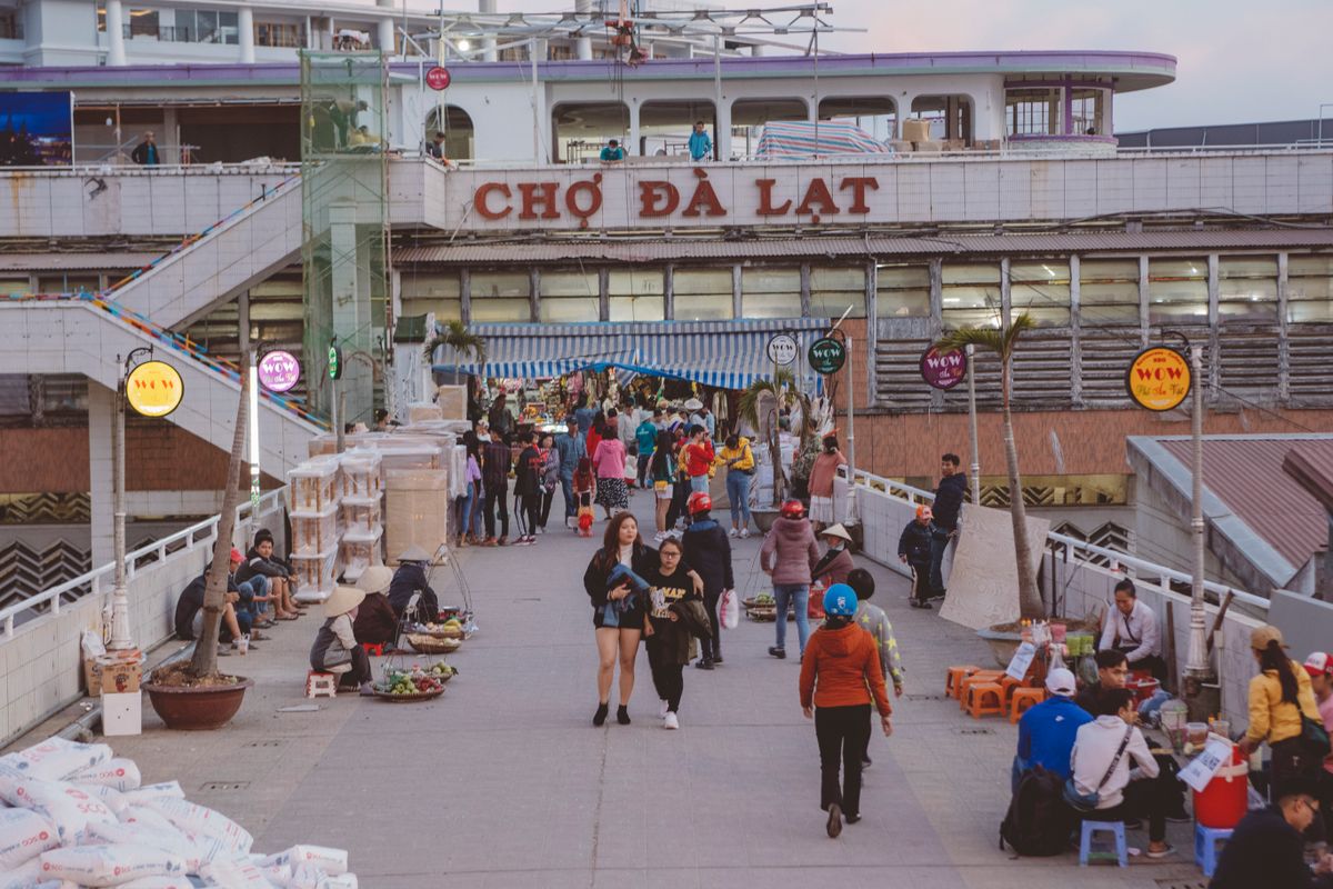 Entrance to Da Lat Market with shoppers on the steps