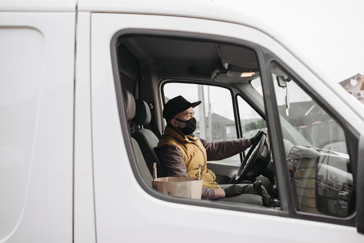 Man In Yellow Vest Driving A Van