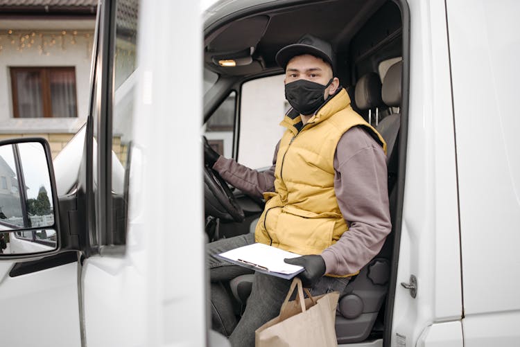 Man Getting Out Of A Delivery Van