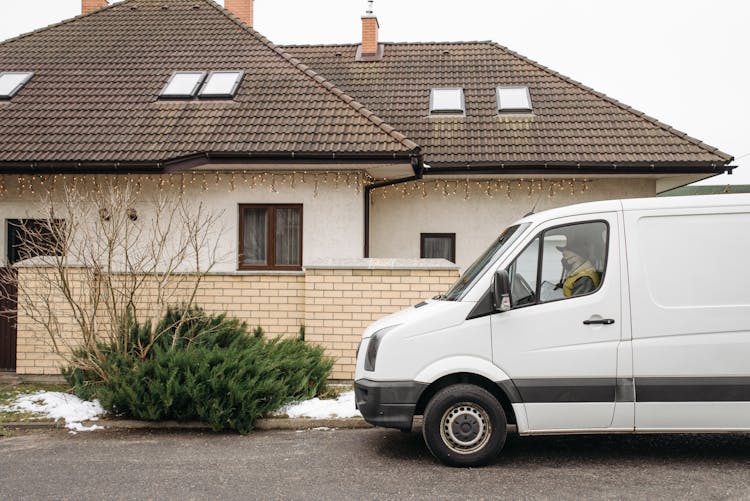 Delivery Van Parked Beside A House