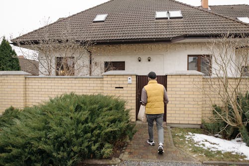 Deliveryman Walking Toward a House