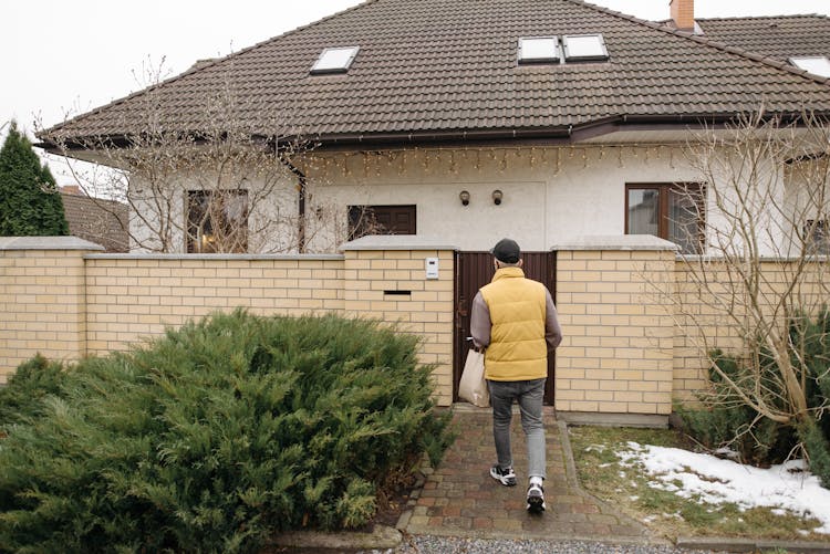 Deliveryman Walking Toward A House