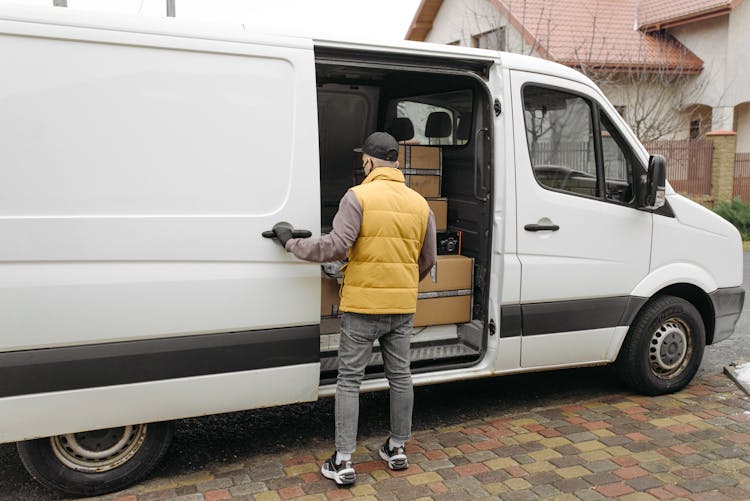 Man Opening A Door Of A Delivery Van