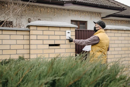 Man Ringing a Doorbell