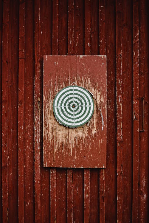 A Dartboard Hanging on a Red Wall