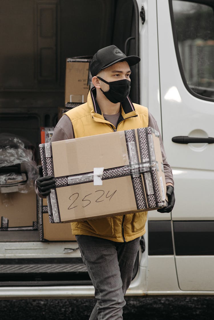 A Deliveryman Carrying A Box