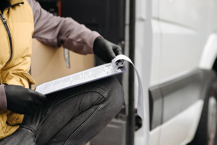 Man Holding A Clipboard With Documents