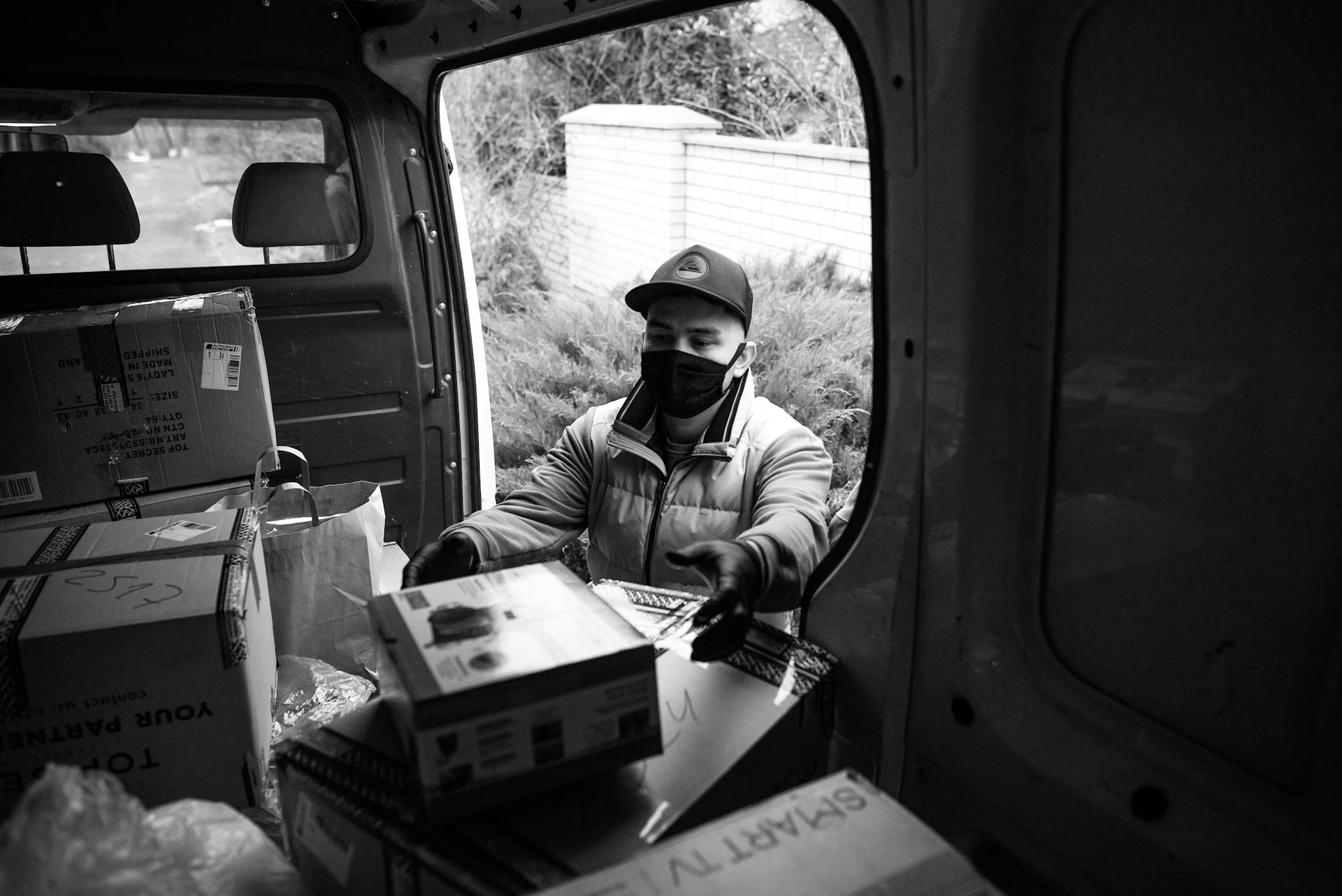 A Deliveryman Taking a Package from the Van