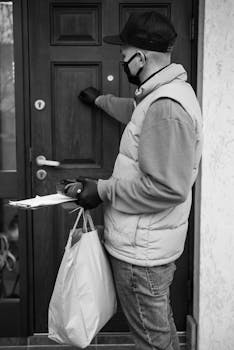 Courier in mask delivering packages, knocking on door in monochrome style.