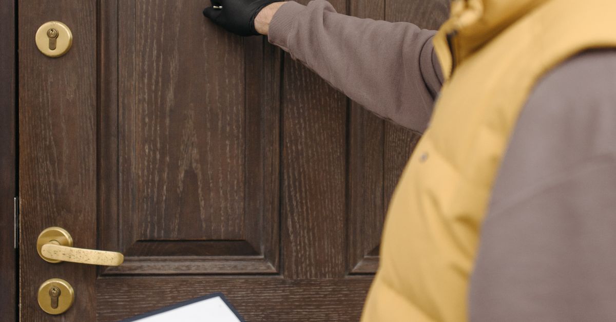 Man Knocking on Wooden Door · Free Stock Photo
