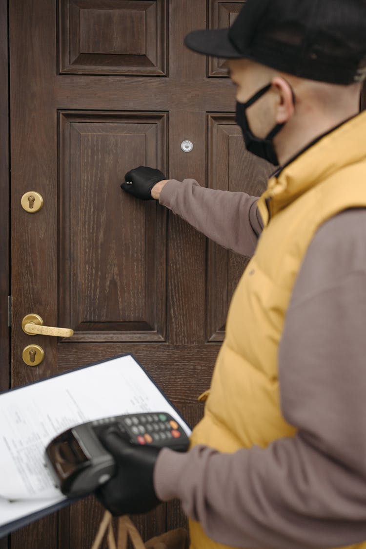 Man Knocking On Wooden Door 