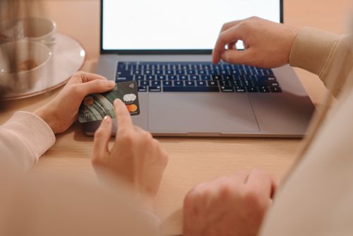 Free Two adults making an online purchase with a laptop and credit card. Stock Photo