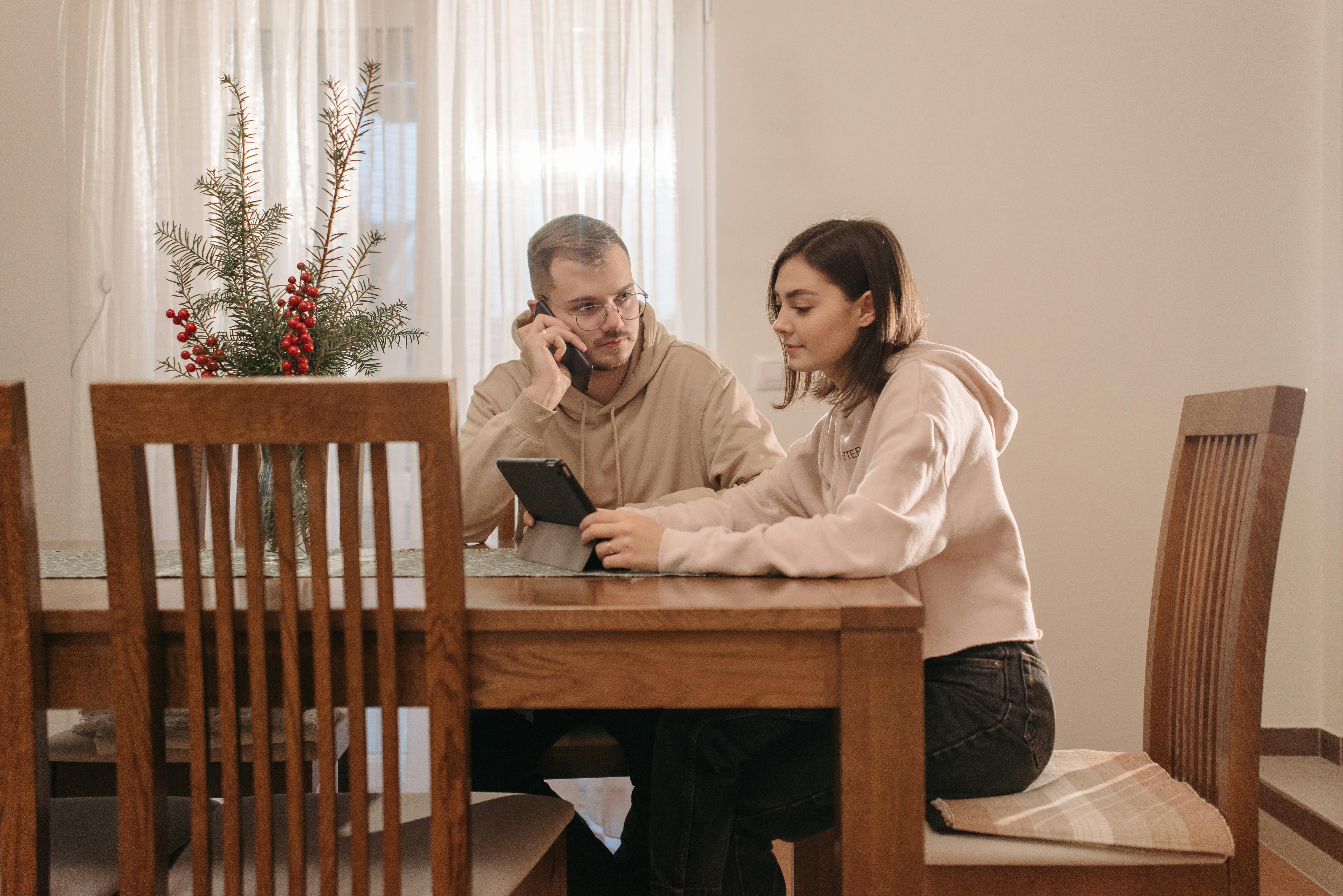 person browsing for rattan chairs on a tablet - high back chairs for sale