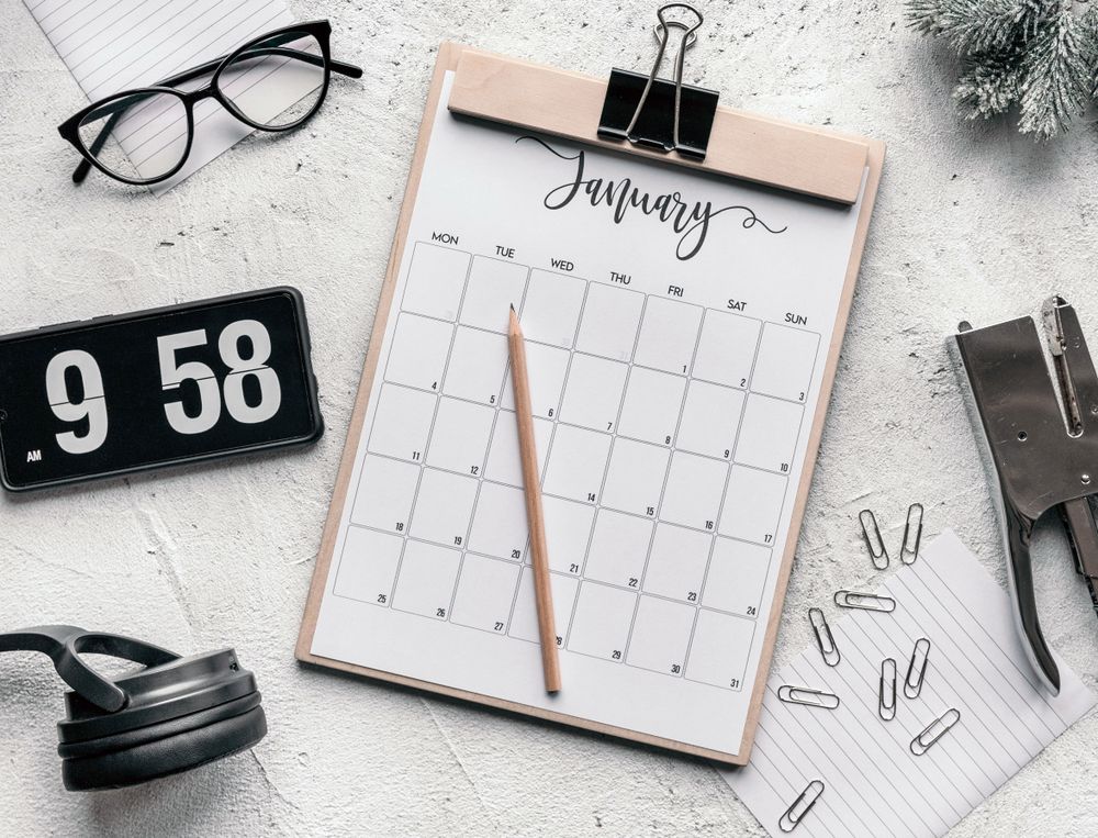 Desk calendar surrounded by modern stationery