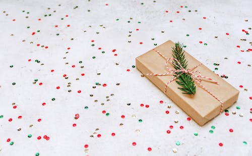 Free Gift box on table with confetti Stock Photo