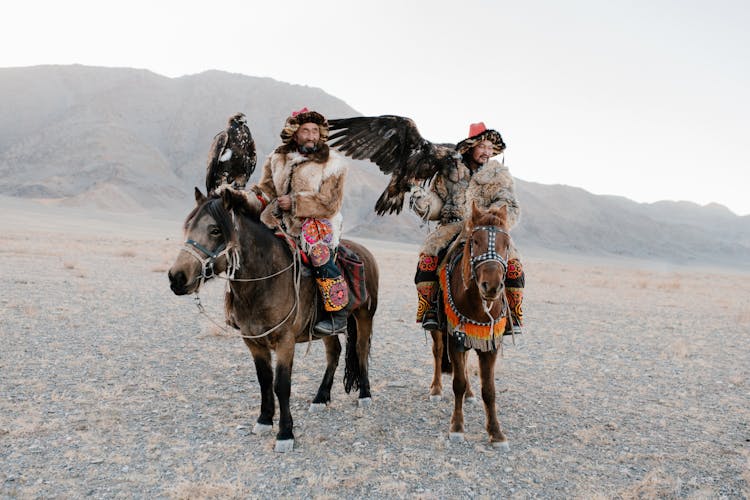 Men In The Desert Riding Horses