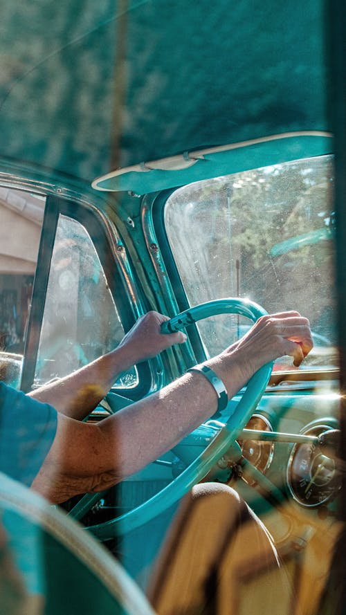 Person Driving a Vintage Car