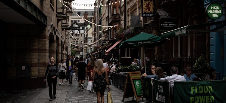 People Walking On The Street Near The Restaurants 