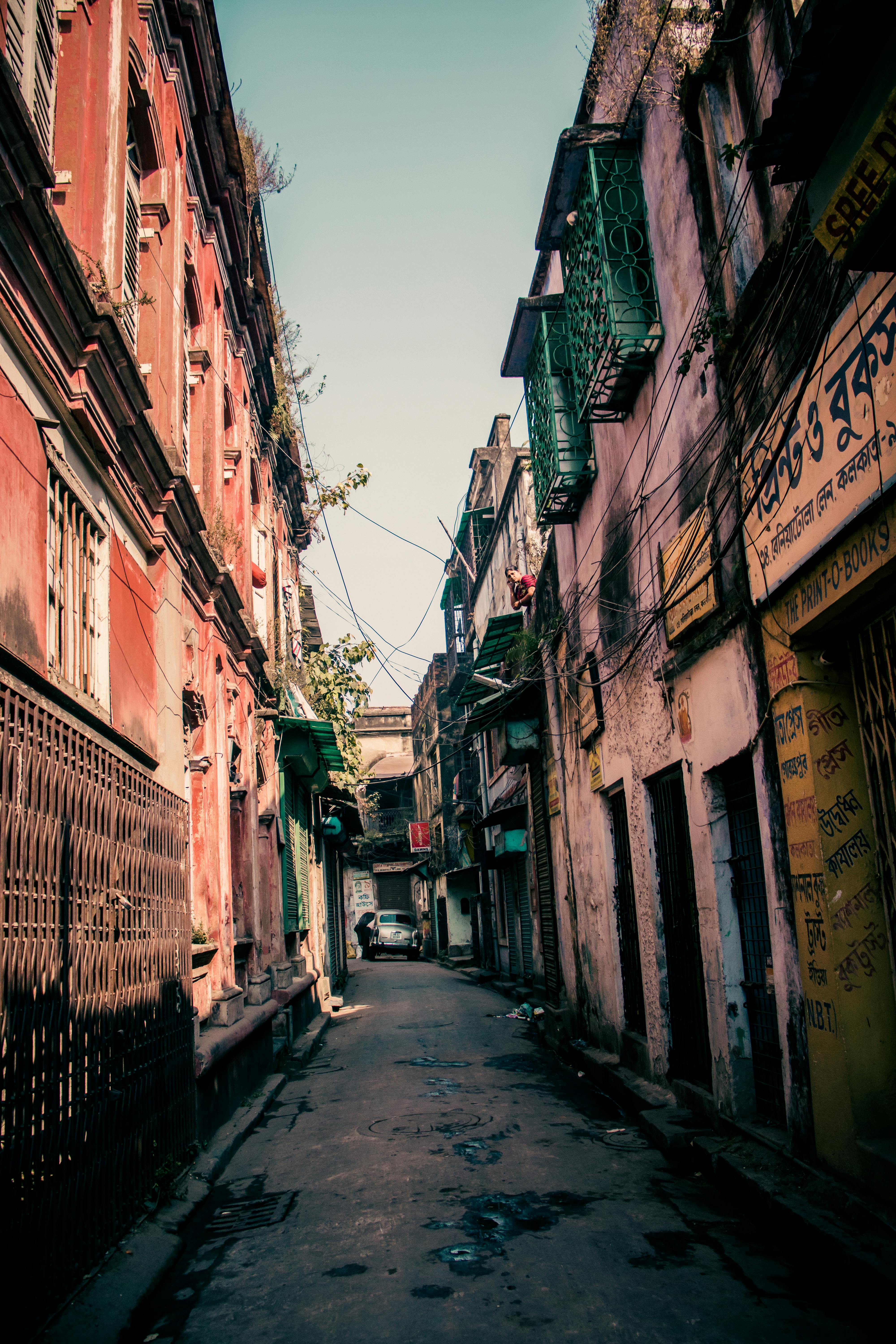 narrow street between old houses in poor district