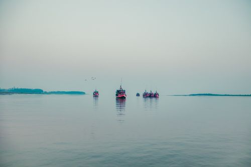 Free Picturesque view of yachts sailing on surface of calm water of ocean on cloudy day Stock Photo