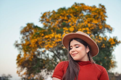 Woman in Red Shirt Wearing Brown Fedora Hat