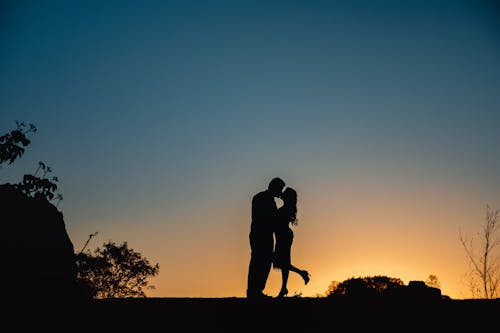 Silhouettes of Couple Kissing on Sunset