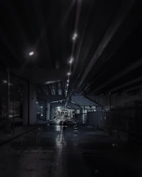 A dark and moody urban tunnel illuminated by streetlights, captured at night in Moscow.