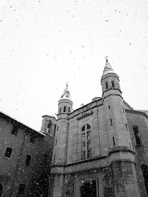 Medieval Roman Catholic cathedral exterior during snowfall