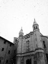Medieval Roman Catholic cathedral exterior during snowfall