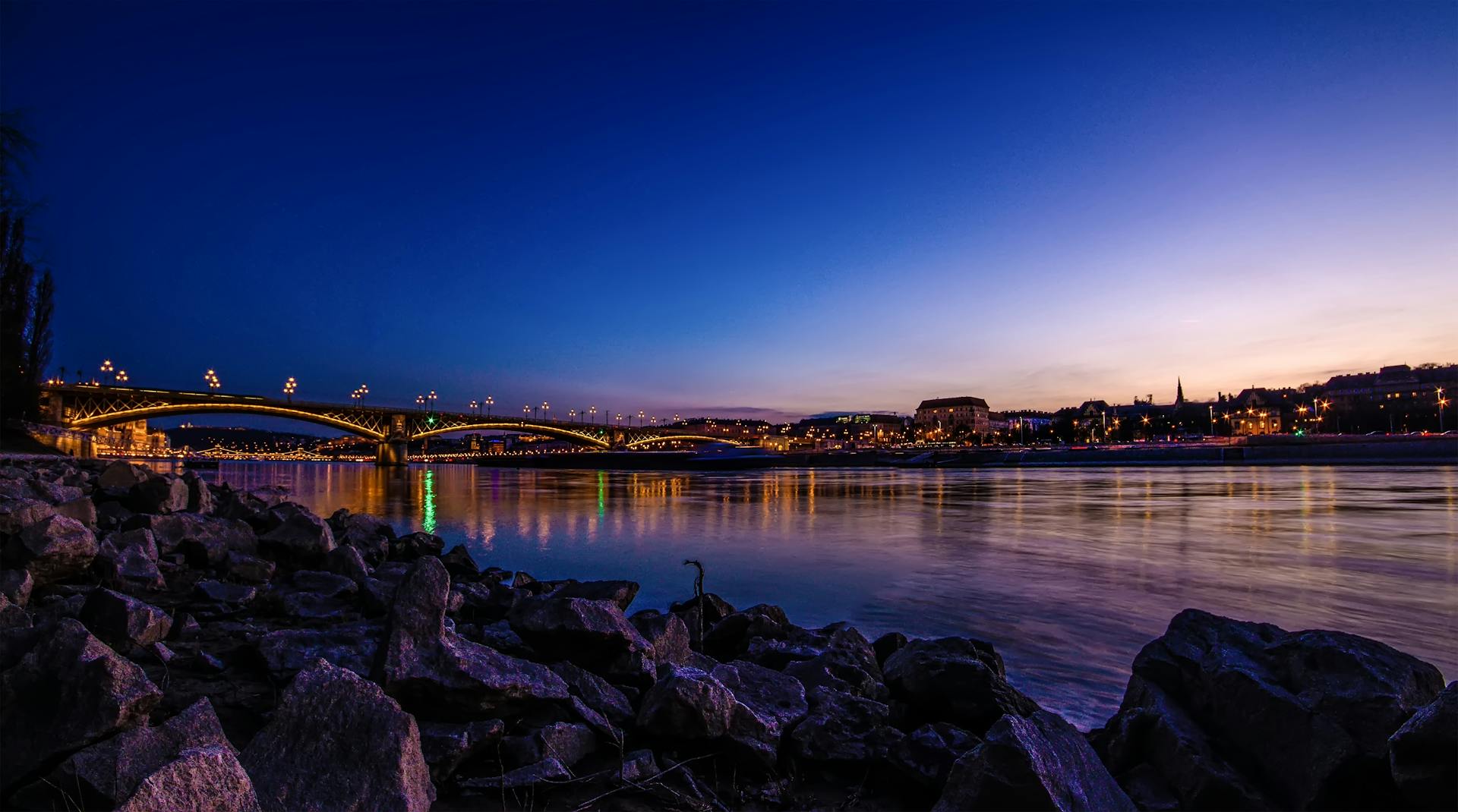 Stunning night view of Budapest's illuminated bridges and cityscape reflecting in the Danube.