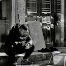 Man Smoking Cigarette and Using Smartphone