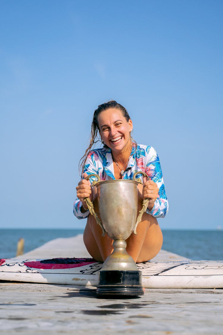 
A Woman Holding A Trophy